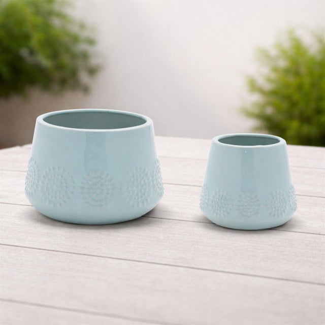 Enhance your space with the bold and modern Ceramic Starburst Pattern Planter Set. Featuring cool blue tones and a glazed...