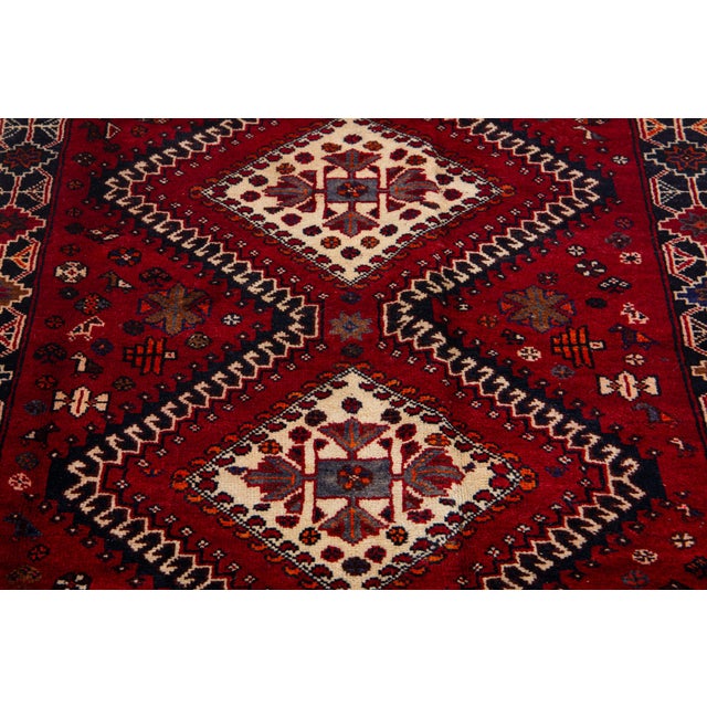 Vintage Persian Hand-Knotted Wool Rug Featuring a Red Field and a Tribal Design For Sale In New York - Image 6 of 10