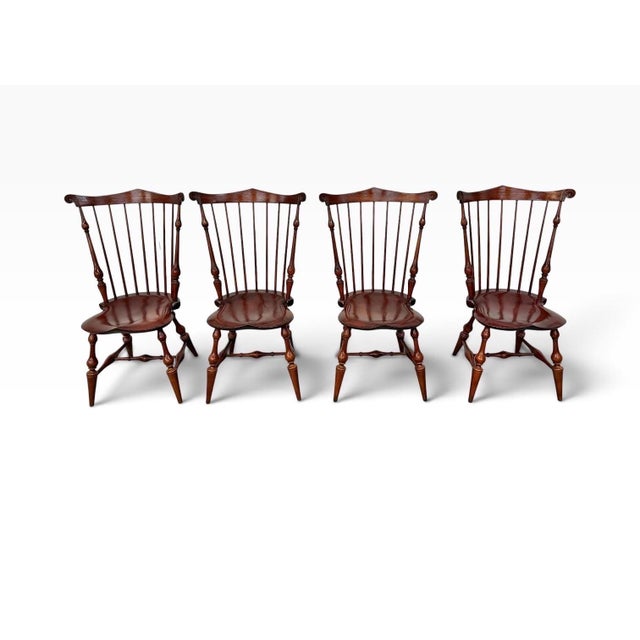 A handsome set of four D.R. Dimes Windsor-style dining chairs, stamped 1992. Crafted from oak and cherry, these chairs...