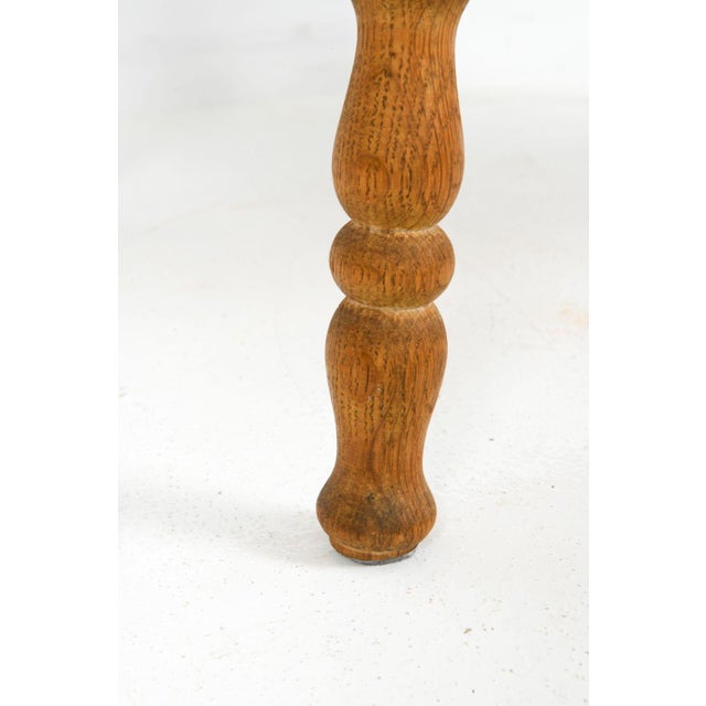 Table has an inlaid tile top in oak with a sculpted frame, circa 1970's.