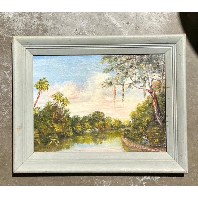 Capture the peaceful beauty of nature with this vintage landscape oil painting on Masonite board, an inviting work that...