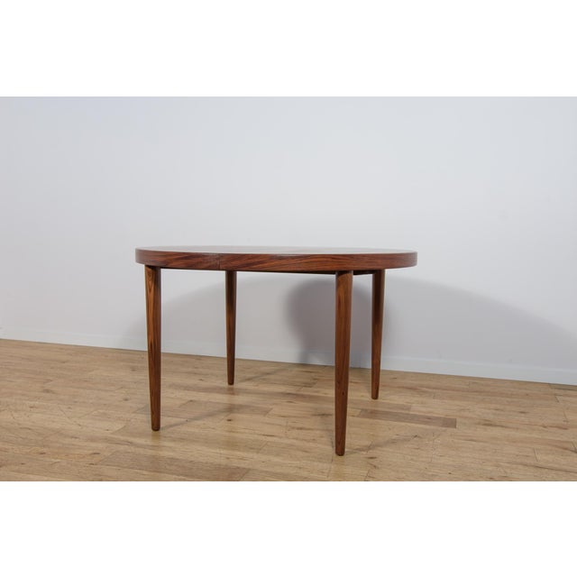 Danish rosewood dining table manufactured by Feldballes Møbelfabrik, dating from the 1960s. The table features a sturdy...