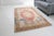 This is a vintage Turkish Oushak rug from the Mid 20th Century. The piece was hand-knotted.