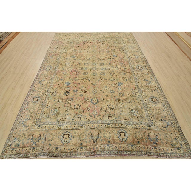 An authentic vintage traditional Tabriz rug hand-knotted with fine wool and natural dyes. This oriental rug features a...