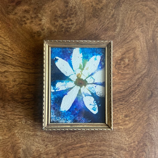 A white blossom radiates with vibrant energy in this small but powerful watercolor. Set against a swirling galaxy of...