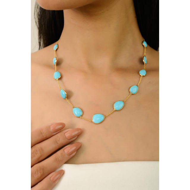 This refined station necklace showcases 11 certified natural turquoise cabochons totaling 24.46 carats, elegantly set in...