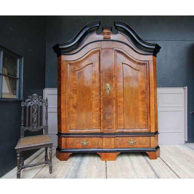 North German baroque cabinet from the late 18th century. Two-door corpus with beveled corners standing on 5 feet. Profiled...