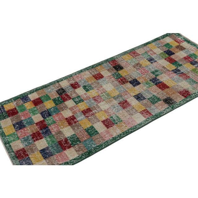 This vintage 2x5 Art Deco rug, hand-knotted in wool, circa 1960-1970, features a mid-century take on Art Deco and cubist...