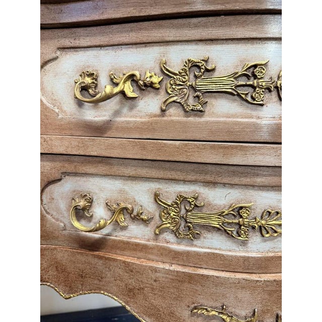 A beautiful vintage French bombe chest featuring a shaped marble top, custom painted and professionally waxed for a soft,...