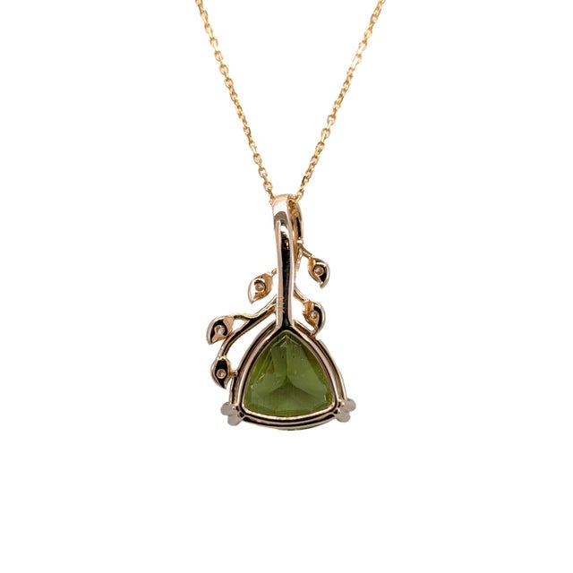 Celebrate vibrant beauty with this 5-carat trillion peridot pendant, accented by sparkling natural diamonds. Crafted in...