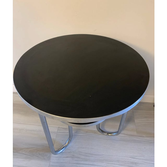 A striking 1940s Bauhaus modern occasional table by Royal Metal Manufacturing, featuring a tiered design with chrome-...