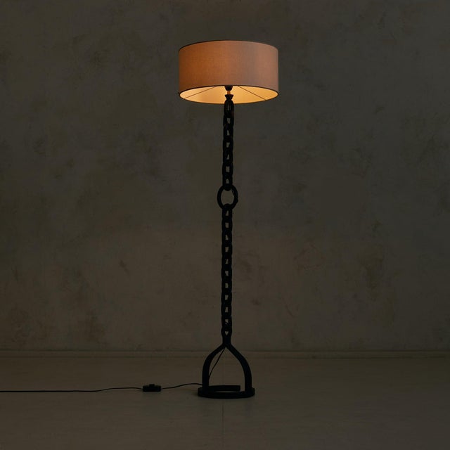 A mid-century French floor lamp, circa 1950s, in the manner of Jean-Pierre Ryckaert. Forged in darkened metal, the...