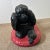 Mid-century black poodle figure on a red cushion. Very fun! Hollywood Regency style.