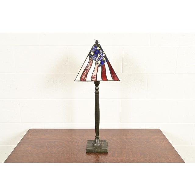 A gorgeous Arts & Crafts style table lamp USA, Circa Late 20th Century Patinated metal base, with American Flag stained...