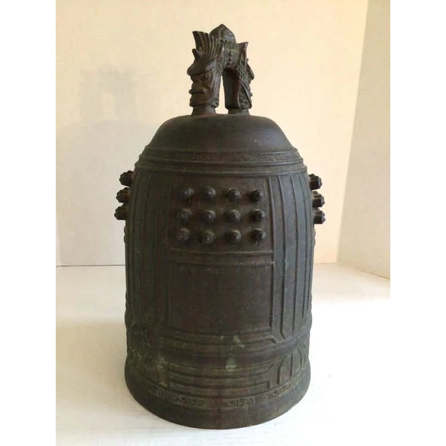 This 19th C. Japanese Buddhist bronze temple or monastery bell, features a stylized two-headed dragon loop handle at top,...