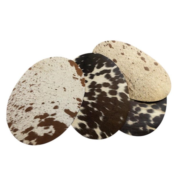 100% authentic (ethically-sourced) rare cowhide placemats. These luxurious, oval-shaped placemats feature soft, artisanal...