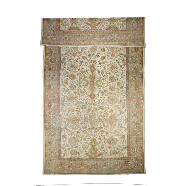 From western Persia, , thuis creamy-straw carepet shows a strong curving arabesque vinery positioning oval palmettes, with...