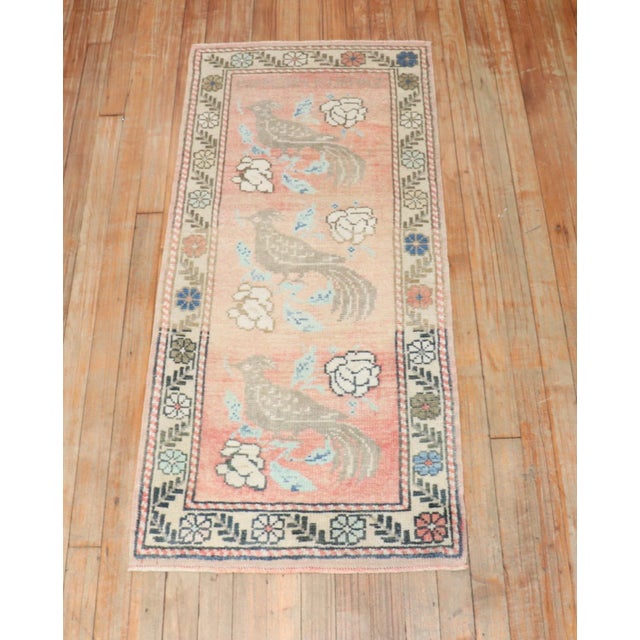 A mid 20th Century small size Turkish rug with a pigeon motif on a peach ground.Professionally Cleaned and able to endure...