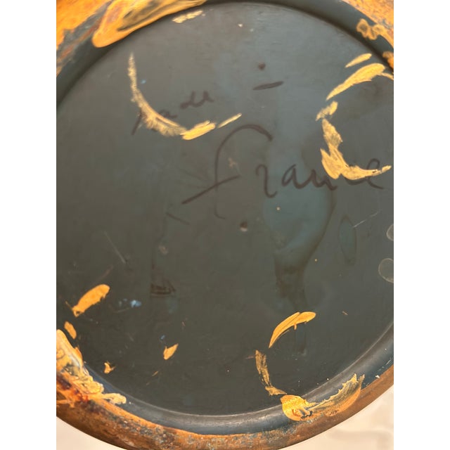 An elegant vintage French tole cachepot featuring a rich deep black finish accented with hand-painted gilt floral and...