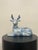 A large late 20th century Thai ceramic deer figurine hand-painted in cobalt blue and white beneath a glossy crackle glaze....