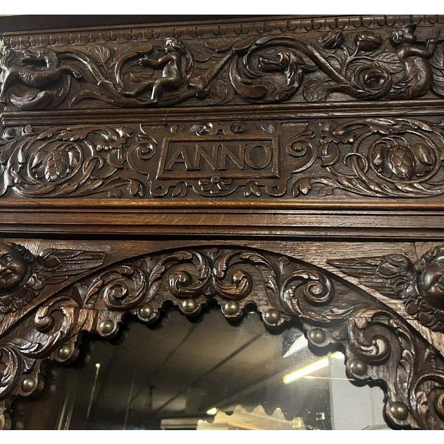 Large, richly carved renaissance-style two-part buffet – “anno 1634” an imposing two-part buffet in carved wood, featuring...