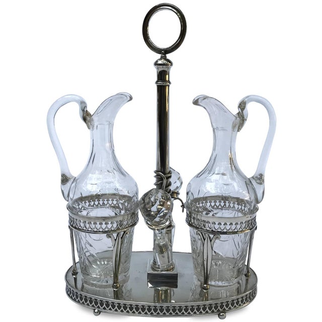 Brescian Silver Oil Cruet, 1812/1872. The cruet's stem, with two bottle holders supported by three stylized leaves, rests...