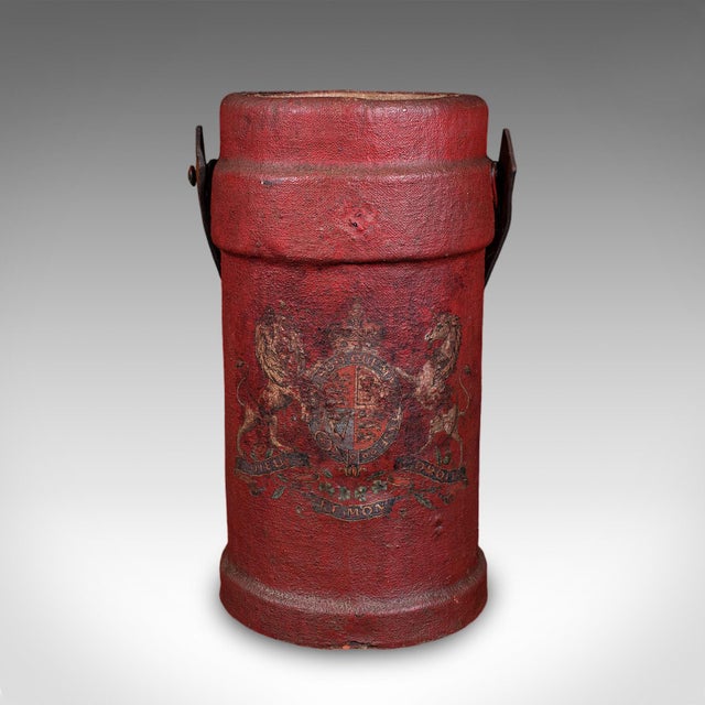 This is a antique decorative stick stand. An English, leather basket or storage bin, dating to the early 20th century,...