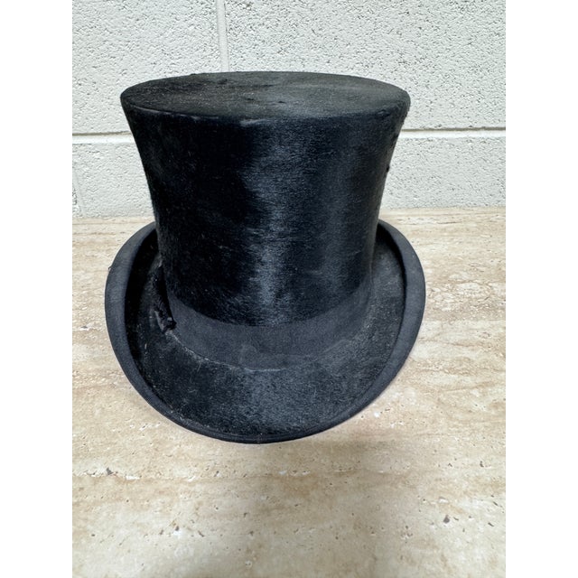 Fabulous authentic black top hat made in England by Sinclair & Co. Excellent vintage condtion and very wearable if you...