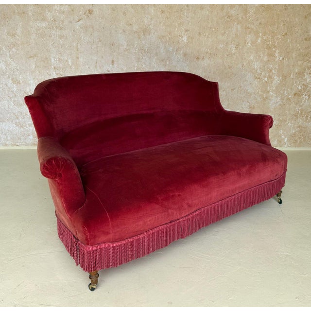 A magnificent small scale 19th century French Napoleon III “chapeau de gendarme” style settee in red velvet with...