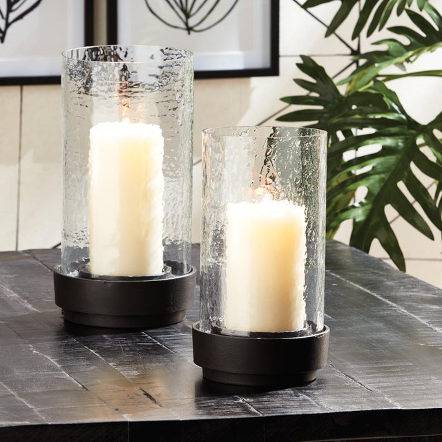 Architectural in design, a simple glass form fits into a grooved metal base. Its warm weathered patina makes it perfect...