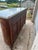 19th Century Louis XVI Demi-Lune Buffet crafted in richly figured walnut with elegant bookmatched veneer panels and a...
