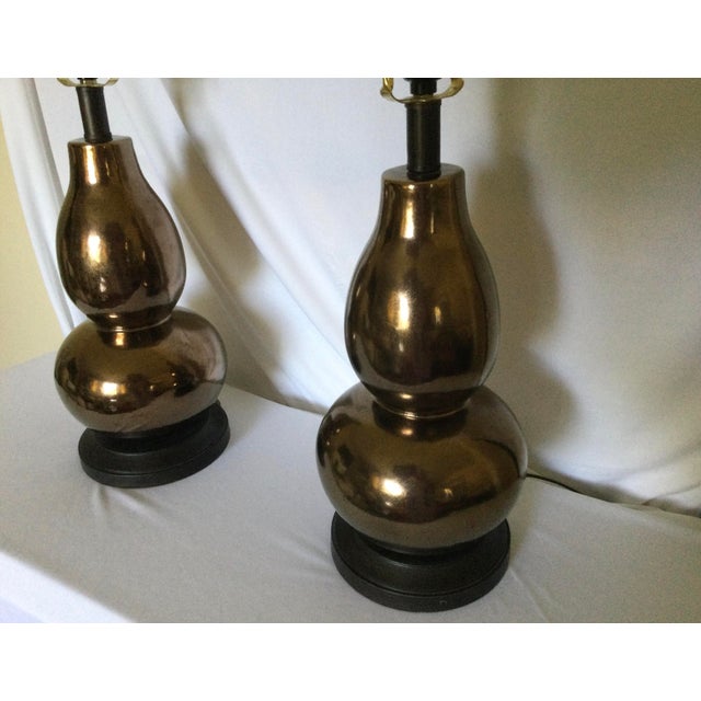 These lamps are made in the style of Christopher Spitzmiller, featuring a double gourd silhouette with a copper or bronze...