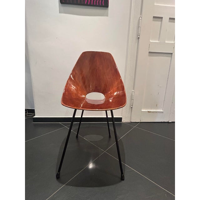 Chair by Vittorio Nobili "Medea", Italy, circa 1955. Curved veneered veneer in santos rosewood, brass, an enameled iron...