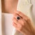 This elegant Art Deco-style three-stone ring features 1 octagon cut blue sapphire totaling 3.33 carats, set in rich 18K...