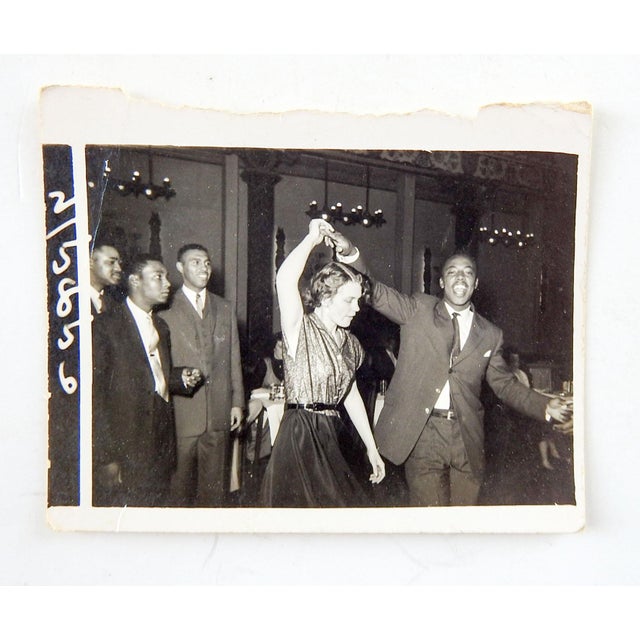 Mid 20th century British vernacular snapshot photograph of a young couple dancing at a party. Back stamp Sunbeam Photo...