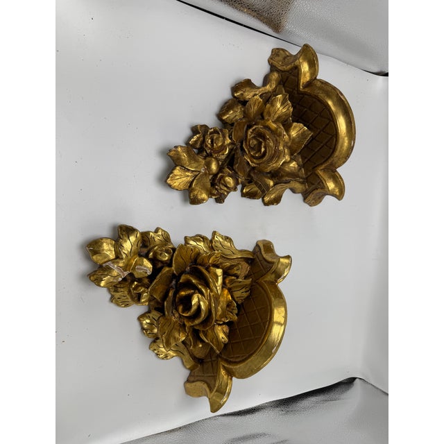 This is a lovely pair of vintage Italian Florentine-style giltwood wall shelves/brackets, richly decorated with...