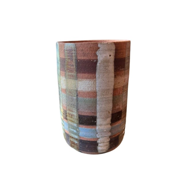 Studio pottery vase painted in plaid design with letters down one side and numbers on a clock on the bottom. Signed on the...
