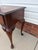 Elegant vintage Queen Anne-style side or lamp table featuring graceful cabriole legs, pad feet, a shaped apron, and a...
