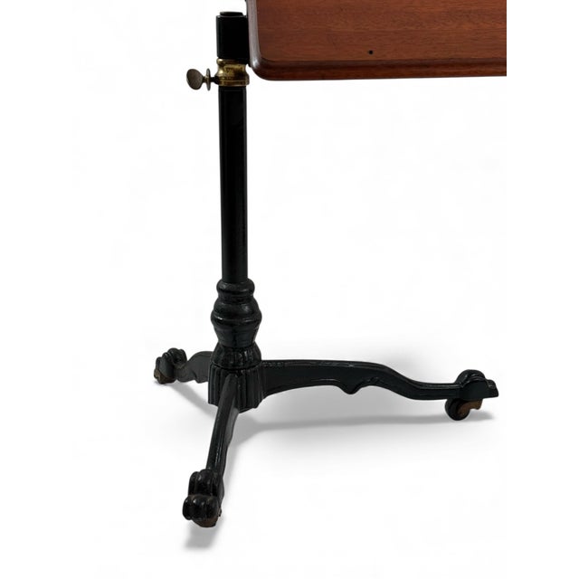 An American reading or small drafting table with a tiltable top and an adjustable height sculptural base. Dating to circa...