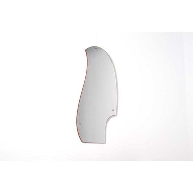 Beautiful mid-century teak low chest with its original sculptural mirror, dating from the 1950s–60s. This refined Danish-...