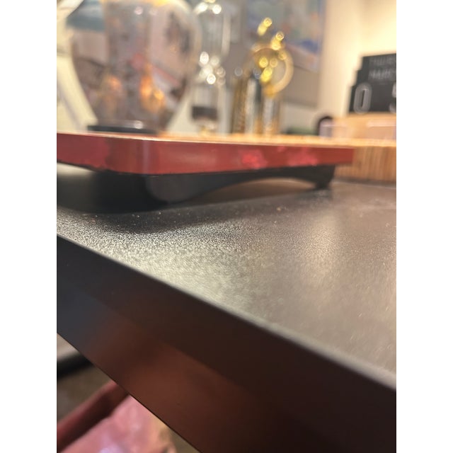 A beautiful vintage Japanese hand-lacquered wooden footed tray featuring an elegant gold maki-e style landscape of soaring...