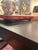 A beautiful vintage Japanese hand-lacquered wooden footed tray featuring an elegant gold maki-e style landscape of soaring...