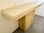 1980s Italian travertine console table, featuring a rectangular top and a single pedestal base. A minimalist piece crafted...