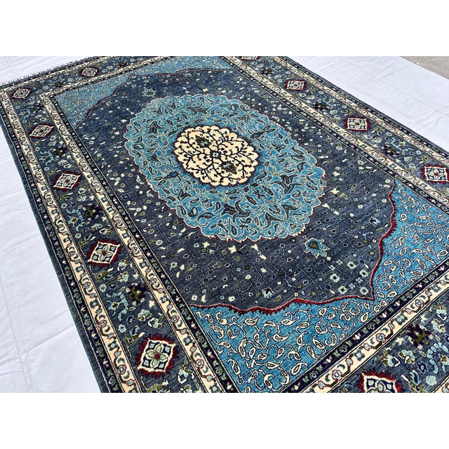 Persian Tabriz design hand-knotted rug featuring a striking round medallion in soft teal blue with an ivory floral rosette...