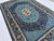 Persian Tabriz design hand-knotted rug featuring a striking round medallion in soft teal blue with an ivory floral rosette...