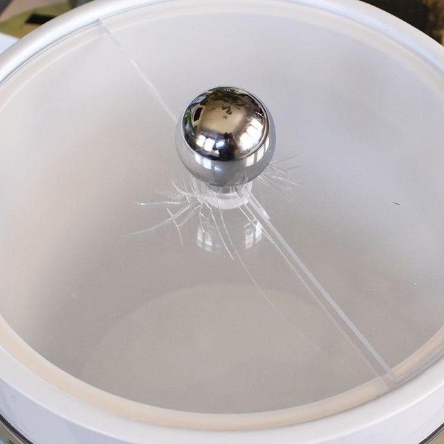 A fun round mid-century modern ice bucket with a lid and acrylic handle. This bright colorful vintage ice bucket will be...