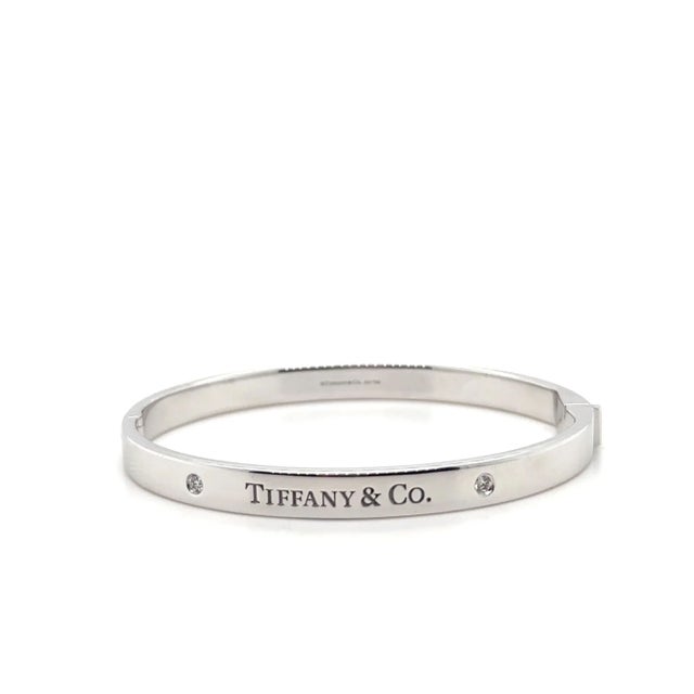 A Tiffany & Co. Diamond bangle, made of 18ct White Gold, and weighing 38.7 gm. Stamped: Tiffany & Co. AU 750. The bangle...