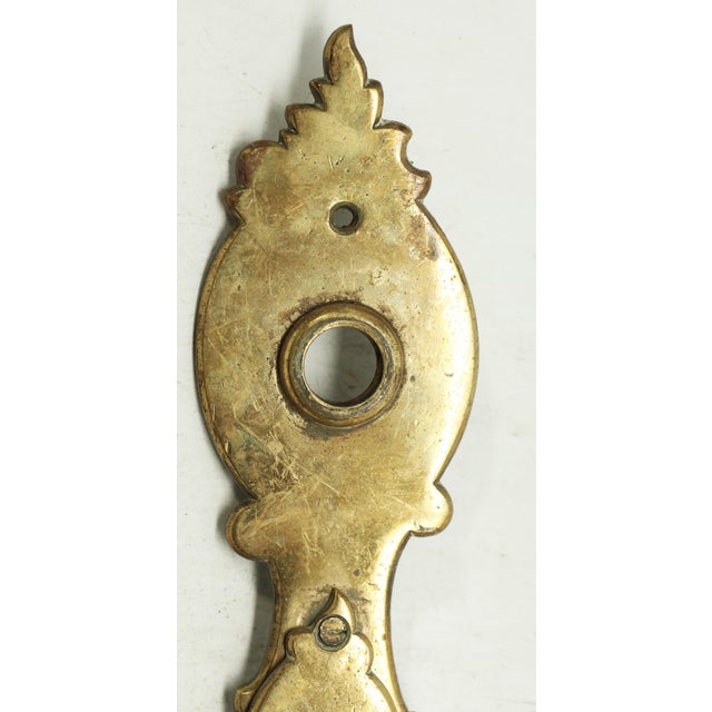European simple brass door back plate with a keyhole cover. The original mounting screws are not available. Good condition...