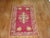 Antique Turkish Ghiordes rug with an enchanting floral palette on a raspberry field circa 1900. Measures: 3'9" x 6'.