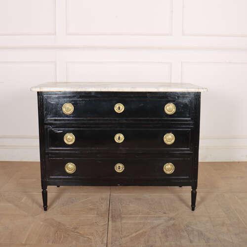 Early 19th Century French ebonized 3 drawer commode with a 3cm thick marble top. 1820 This piece is designed in the style...